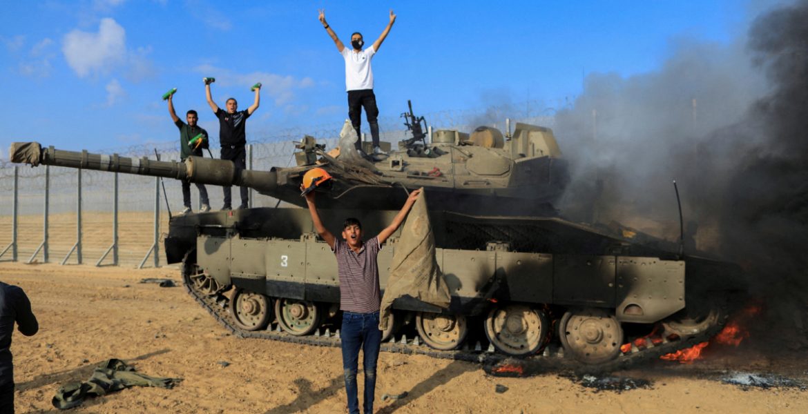 فلسطينيون يحتفلون فوق دبابة إسرائيلية/ رويترز