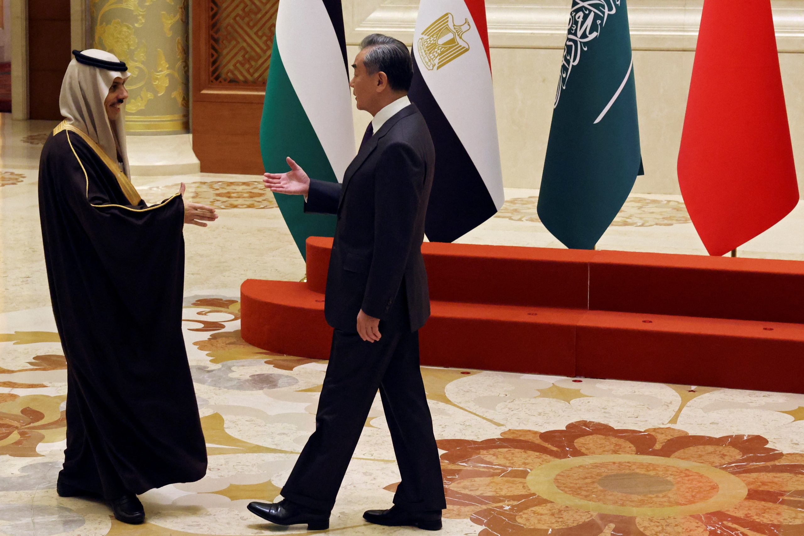 وزير الخارجية الصيني وانغ يي يصافح وزير الخارجية السعودي الأمير فيصل بن فرحان آل سعود/ رويترز